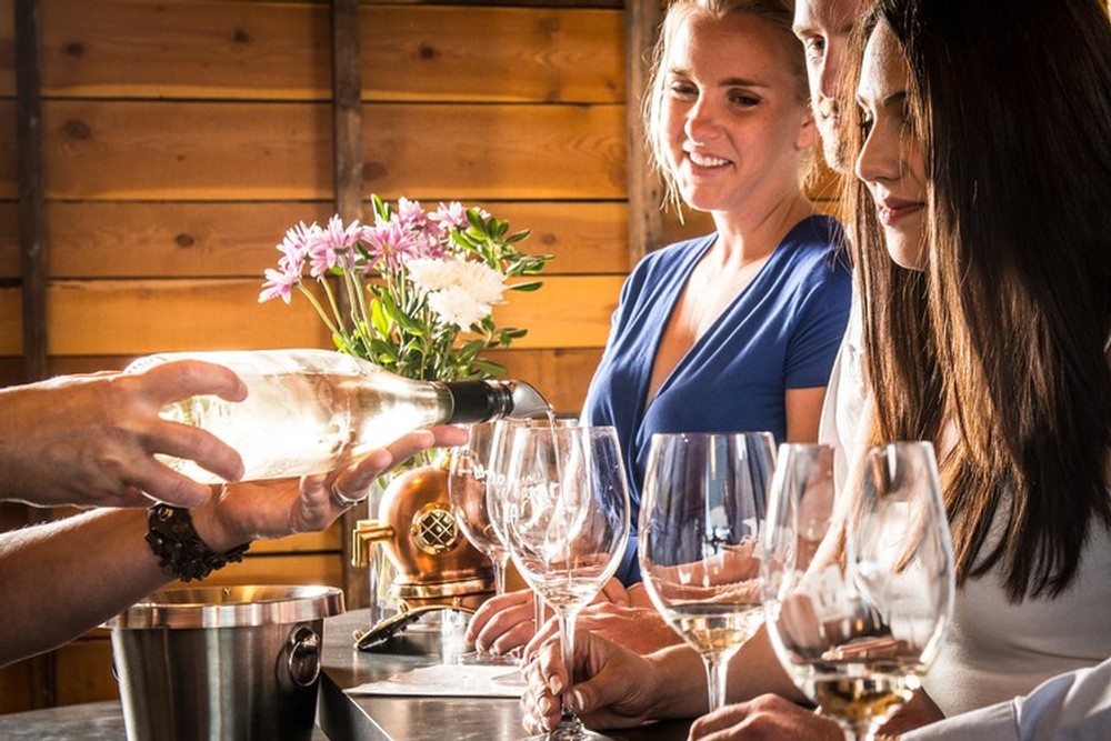 Three people tasting wine at the tasting room